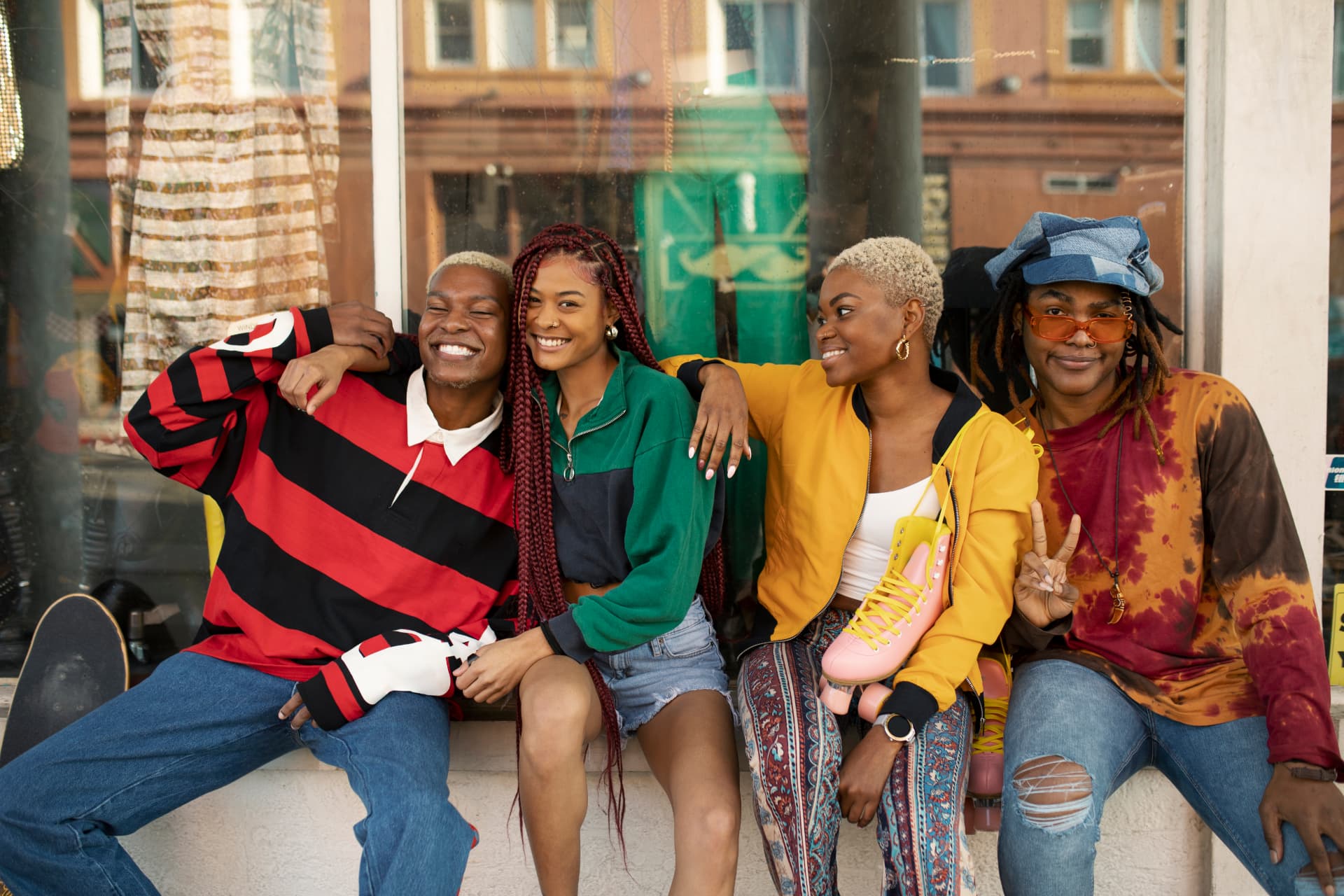 A group of young friends smiling together outside a city clothing store